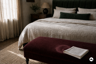 Small perfume ring on a burgundy velvet footstool in the bedroom