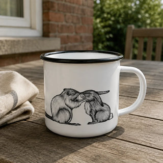 Ligarti emaille mok bever & konijn – 300 ml van dichtbij in gebruik, met de illustratie en dunne zwarte emaille rand zichtbaar.