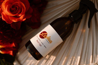 Lolaa Red Lips interieurparfum fles met rozen en natuurlijke achtergrond