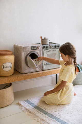 Kind speelt met de wasmachinemand