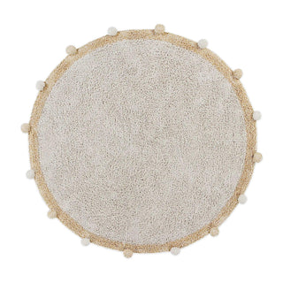 Rond naturel vloerkleed met honingkleurige rand en pompons.
