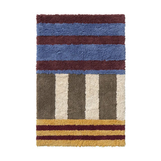 Color On-badmat met blauwe, bordeauxrode, gele en lichte stroken.
