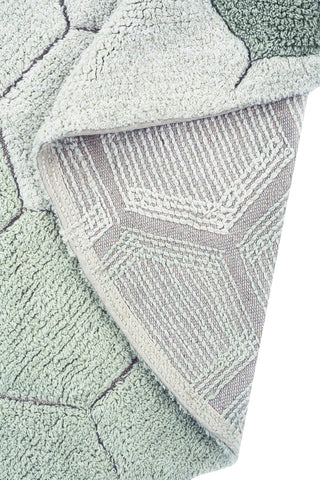 Omgeslagen hoek van het blauwgroene Comb-vloerkleed.