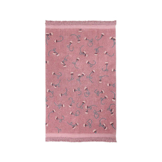 Roze vloerkleed met takjesmotieven en franjes.