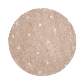 Rond roze vloerkleed met lichte stippen.
