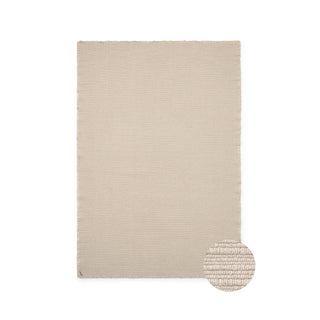 Naturelkleurig Handloom-vloerkleed, met ronde detailinzet van de weefstructuur.