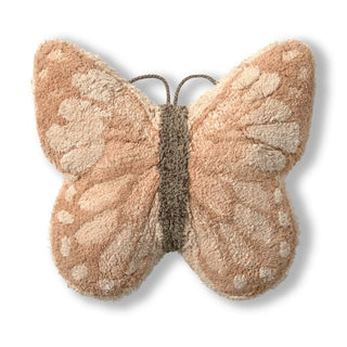 Vlindervormig vloerkussen in beige en roze tinten.