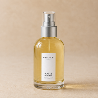 Detailopname van Millefiori Milano Home Spray 100 ml Honey & Sea Salt met transparante overkap, zilveren verstuiver en glazen flacon.