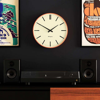 Radio City wandklok lines oranje 33cm van Newgate, geplaatst in een stijlvolle werk- of woonomgeving