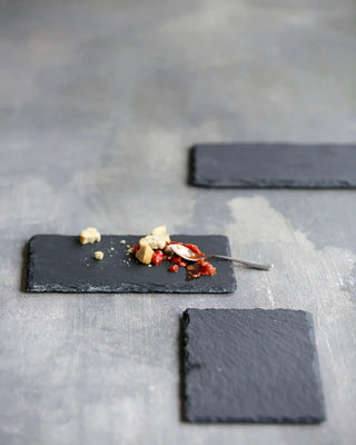 Serveerplank Slate Grijs 12x20cm van Nicolas Vahe, in een culinaire setting met bijpassende ingrediënten